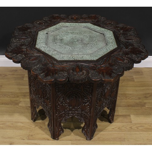 2641 - An Anglo-Indian teak folding Hoshiarpur table, carved throughout with peacocks and trailing stems, o... 