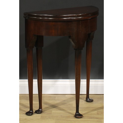 1738 - A George II Revival mahogany demilune tea table, of small proportions, hinged top above a deep friez... 