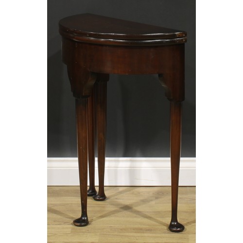 1738 - A George II Revival mahogany demilune tea table, of small proportions, hinged top above a deep friez... 