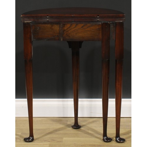 1738 - A George II Revival mahogany demilune tea table, of small proportions, hinged top above a deep friez... 