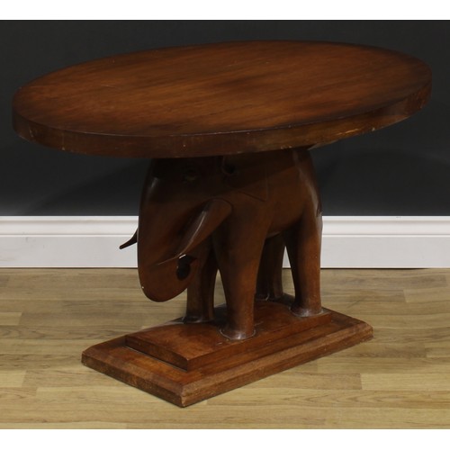 2643 - An Art Deco mahogany occasional table, oval top, the support carved as an elephant, stepped rectangu... 