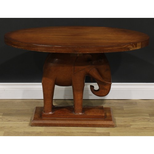 2643 - An Art Deco mahogany occasional table, oval top, the support carved as an elephant, stepped rectangu... 