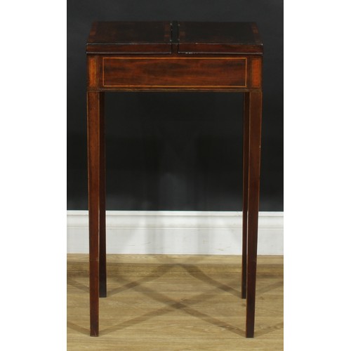 2038 - A George III rosewood and mahogany work table, flush top with crossbanded twin covers hinged to the ... 