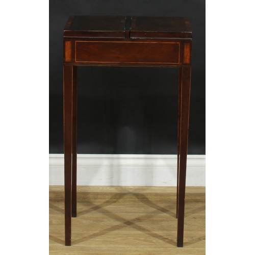 2038 - A George III rosewood and mahogany work table, flush top with crossbanded twin covers hinged to the ... 