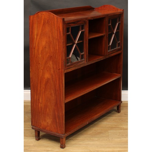 1877 - An Edwardian mahogany low library bookcase, shallow three-quarter gallery above an arrangement of sh... 