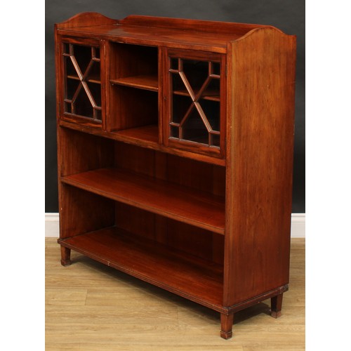 1877 - An Edwardian mahogany low library bookcase, shallow three-quarter gallery above an arrangement of sh... 