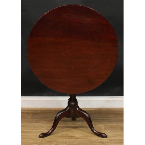 1938 - A George III mahogany tripod occasional table, one-piece circular tilting top, birdcage support, tur... 