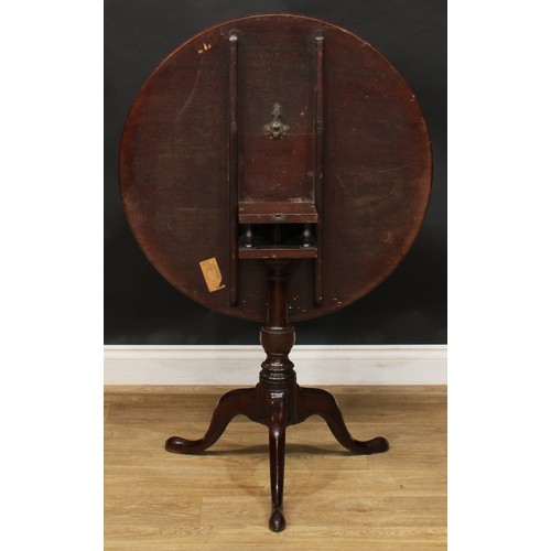 1938 - A George III mahogany tripod occasional table, one-piece circular tilting top, birdcage support, tur... 