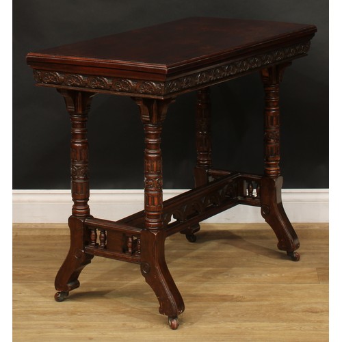 2592 - A Victorian Neo-Gothic oak card table, hinged top enclosing a baize lined playing surface above a de... 