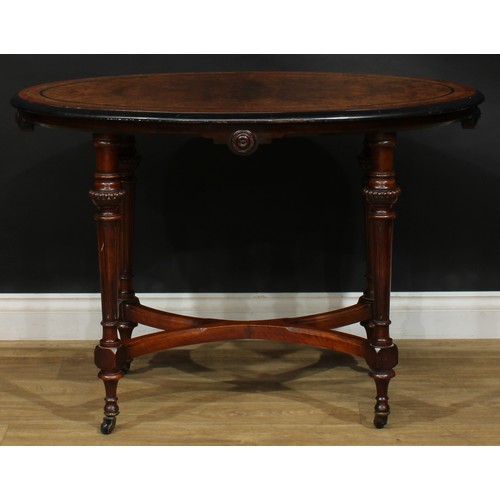 2576 - A Victorian Aesthetic Movement amboyna banded walnut and parcel-ebonised centre table, oval top, flu... 