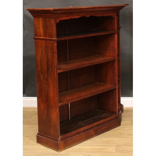 2400 - An unusual early 20th century open bookcase, oversailing top with moulded edge above open shelves an... 