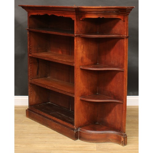 2400 - An unusual early 20th century open bookcase, oversailing top with moulded edge above open shelves an... 