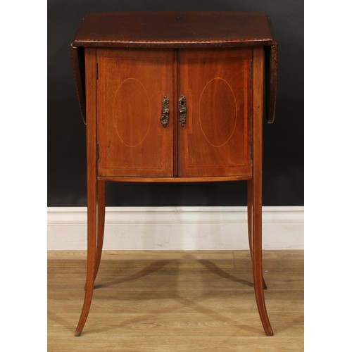 1879 - An Edwardian mahogany Pembroke-form bedroom cabinet, oval top with fall leaves above a pair of satin... 