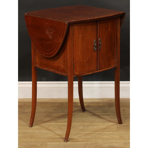 1879 - An Edwardian mahogany Pembroke-form bedroom cabinet, oval top with fall leaves above a pair of satin... 