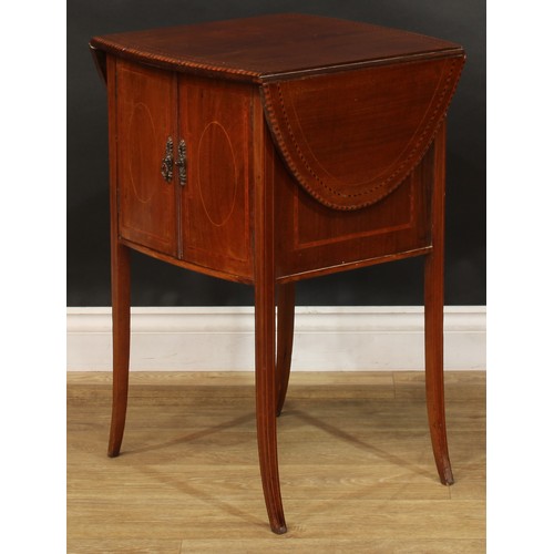 1879 - An Edwardian mahogany Pembroke-form bedroom cabinet, oval top with fall leaves above a pair of satin... 