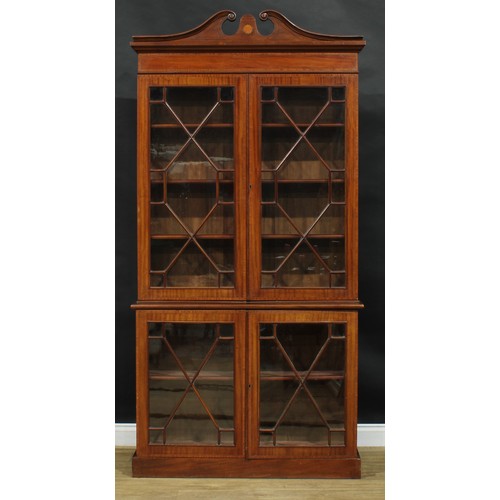 2563 - A Sheraton Revival satinwood crossbanded mahogany library bookcase, of neat slim proportions, swan n... 