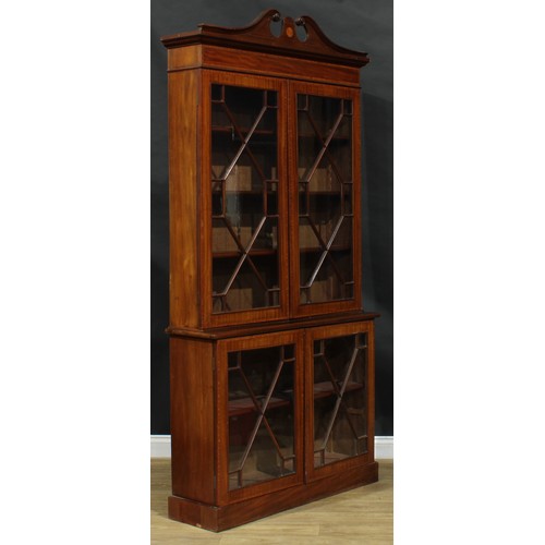 2563 - A Sheraton Revival satinwood crossbanded mahogany library bookcase, of neat slim proportions, swan n... 