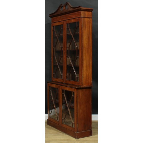 2563 - A Sheraton Revival satinwood crossbanded mahogany library bookcase, of neat slim proportions, swan n... 