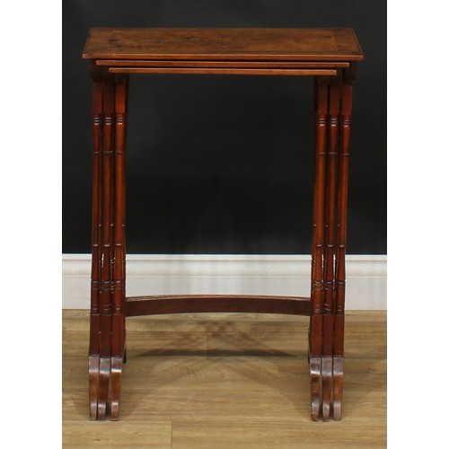 2125 - A George III Revival burr yew nest of three occasional tables, the tops outlined with boxwood string... 