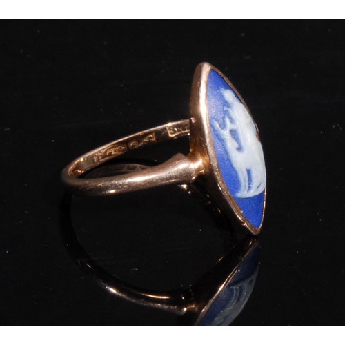 1323 - A 9ct gold and jasperware ring, the navette shaped tablet sprigged in the Grand Tour taste with Dian... 