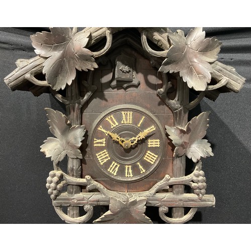 1748 - A Black Forest cuckoo clock, 13cm dial applied with Roman numerals, the case crested by a cockerel a... 