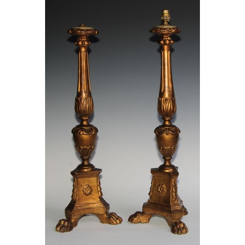 2533 - A pair of tall early 20th century giltwood and gesso table lamps, as North European altar candlestic... 