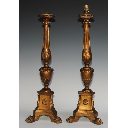 2533 - A pair of tall early 20th century giltwood and gesso table lamps, as North European altar candlestic... 