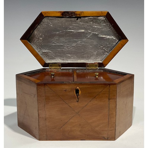 2459 - A George III mahogany lozenge shaped tea caddy, hinged cover enclosing a pair of lidded compartments... 