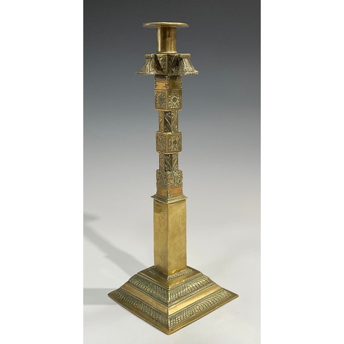 2089 - A pair of large 19th century Indian gilt brass candlesticks, cast and chased with stylised lotus and... 