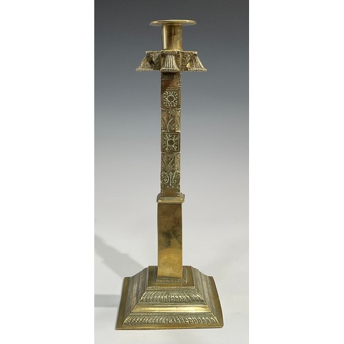 2089 - A pair of large 19th century Indian gilt brass candlesticks, cast and chased with stylised lotus and... 