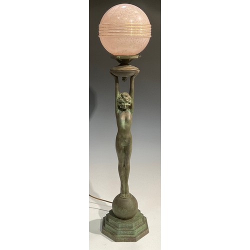 2646 - An Art Deco style copper figural table lamp, as a female nude, glass globular shade, stepped octagon... 