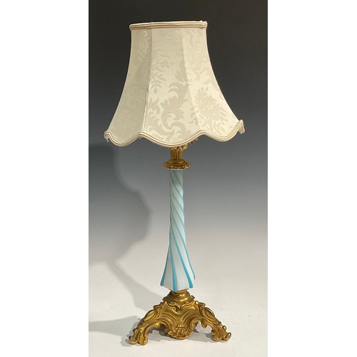 2668 - An early 20th century gilt metal and Bohemian glass table lamp, wrythen pillar, the triform base cas... 