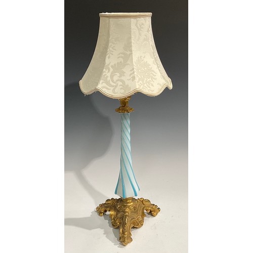 2668 - An early 20th century gilt metal and Bohemian glass table lamp, wrythen pillar, the triform base cas... 