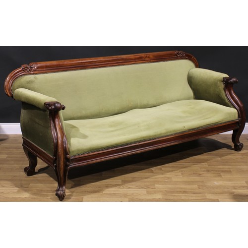 2588 - A Victorian mahogany sofa, the cresting rail carved with flowers and leaves, stuffed-over upholstery... 