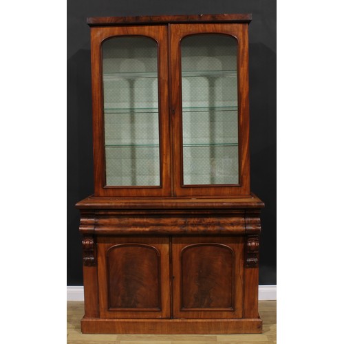 2584 - A Victorian mahogany library bookcase, rectangular cornice above a pair of arched glazed doors, the ... 