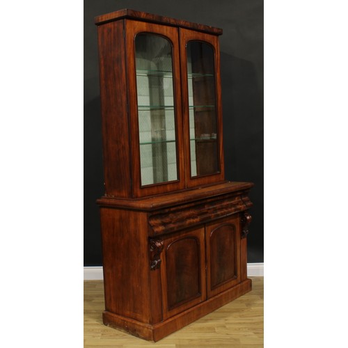 2584 - A Victorian mahogany library bookcase, rectangular cornice above a pair of arched glazed doors, the ... 