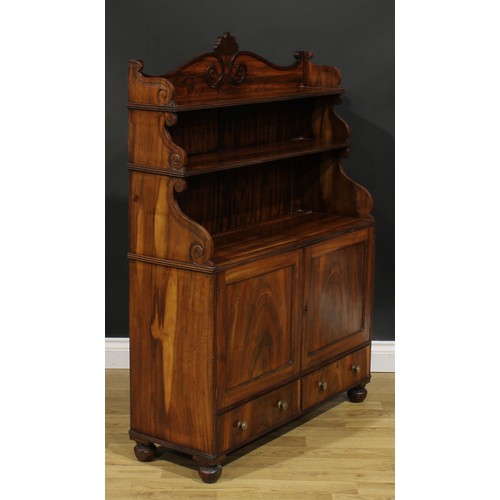 1985 - A Post-Regency waterfall library bookcase cabinet, three-quarter gallery carved with scrolls, the pr... 