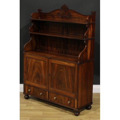 1985 - A Post-Regency waterfall library bookcase cabinet, three-quarter gallery carved with scrolls, the pr... 