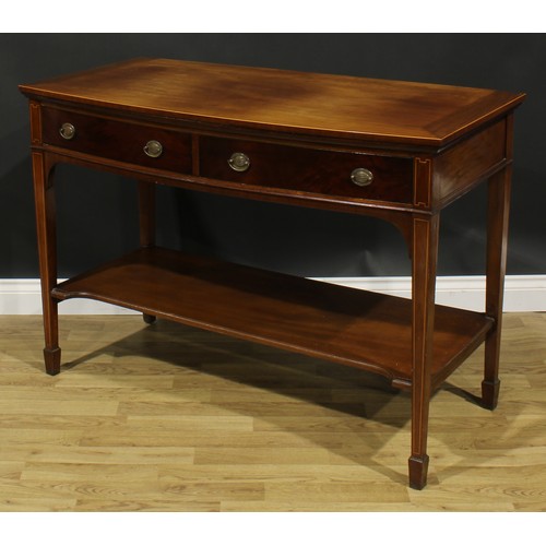 2128 - A George III Revival mahogany bowfront serving or side table, oversailing top above a pair of frieze... 