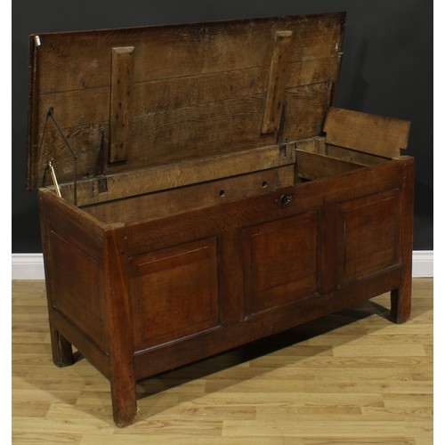 2664 - An early 18th century oak blanket chest, hinged top enclosing a till, above three raised and fielded... 