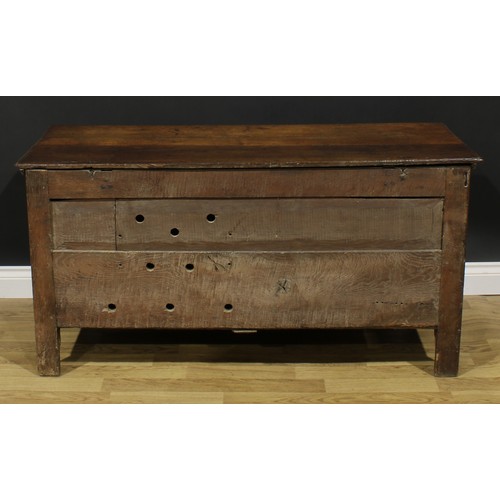 2664 - An early 18th century oak blanket chest, hinged top enclosing a till, above three raised and fielded... 