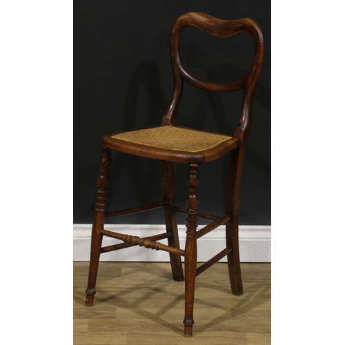 2683 - An early Victorian faux-rosewood music room chair, kidney shaped back, cane seat, turned legs and st... 