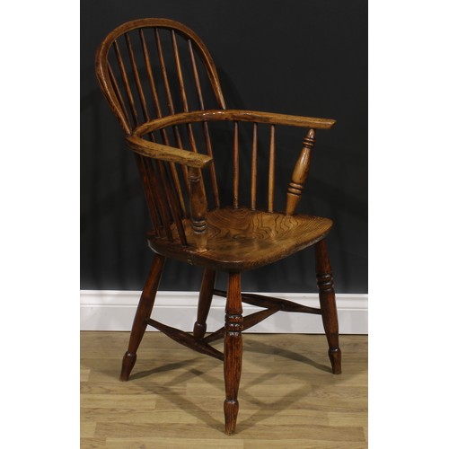 1574 - A 19th century ash and elm Windsor elbow chair, low hoop back, saddle seat, H-stretcher, 95cm high, ... 