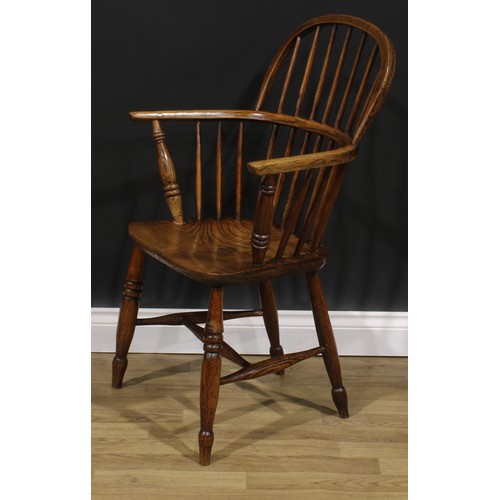 1574 - A 19th century ash and elm Windsor elbow chair, low hoop back, saddle seat, H-stretcher, 95cm high, ... 