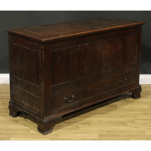 1947 - A George III oak mule chest, hinged two panel top, above a long drawer, skirted base, ogee bracket f... 