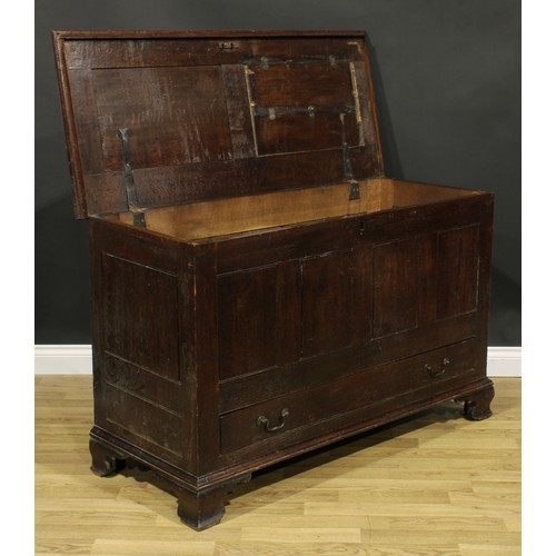 1947 - A George III oak mule chest, hinged two panel top, above a long drawer, skirted base, ogee bracket f... 