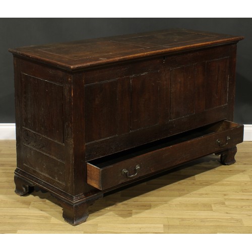 1947 - A George III oak mule chest, hinged two panel top, above a long drawer, skirted base, ogee bracket f... 