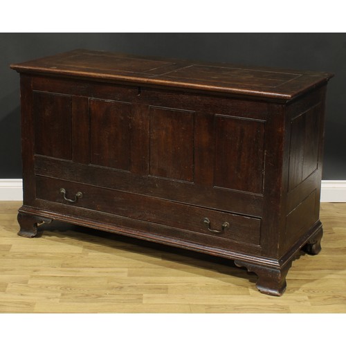 1947 - A George III oak mule chest, hinged two panel top, above a long drawer, skirted base, ogee bracket f... 