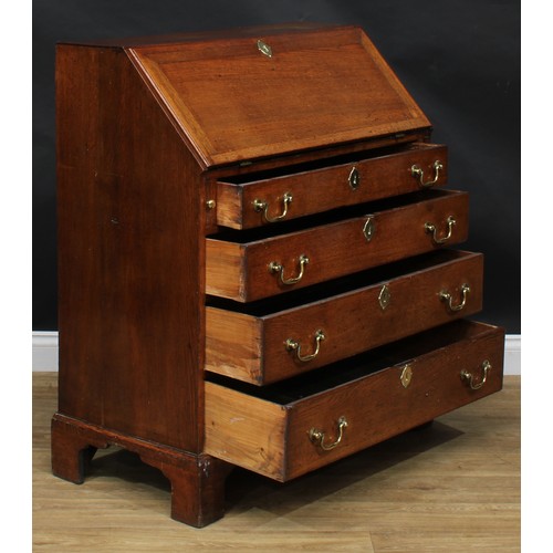 1941 - A George III oak bureau, fall front enclosing a small door, small drawers and pigeonholes, above fou... 