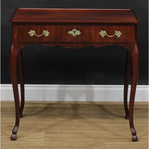 1702 - A 19th century mahogany silver table, dished rectangular top above a long frieze drawer, shaped apro... 